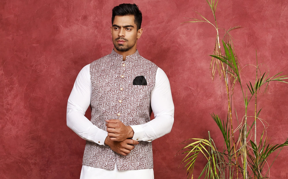 1.	Ivory jacquard waist coat with hand-stitched buttons and a front signature logo, worn over an off-white shalwar kameez for a nikkah