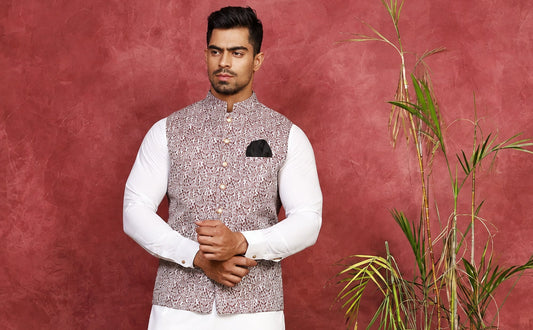 1.	Ivory jacquard waist coat with hand-stitched buttons and a front signature logo, worn over an off-white shalwar kameez for a nikkah